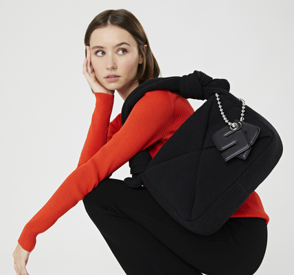Woman carrying a Demi-Pull velvet designer bag