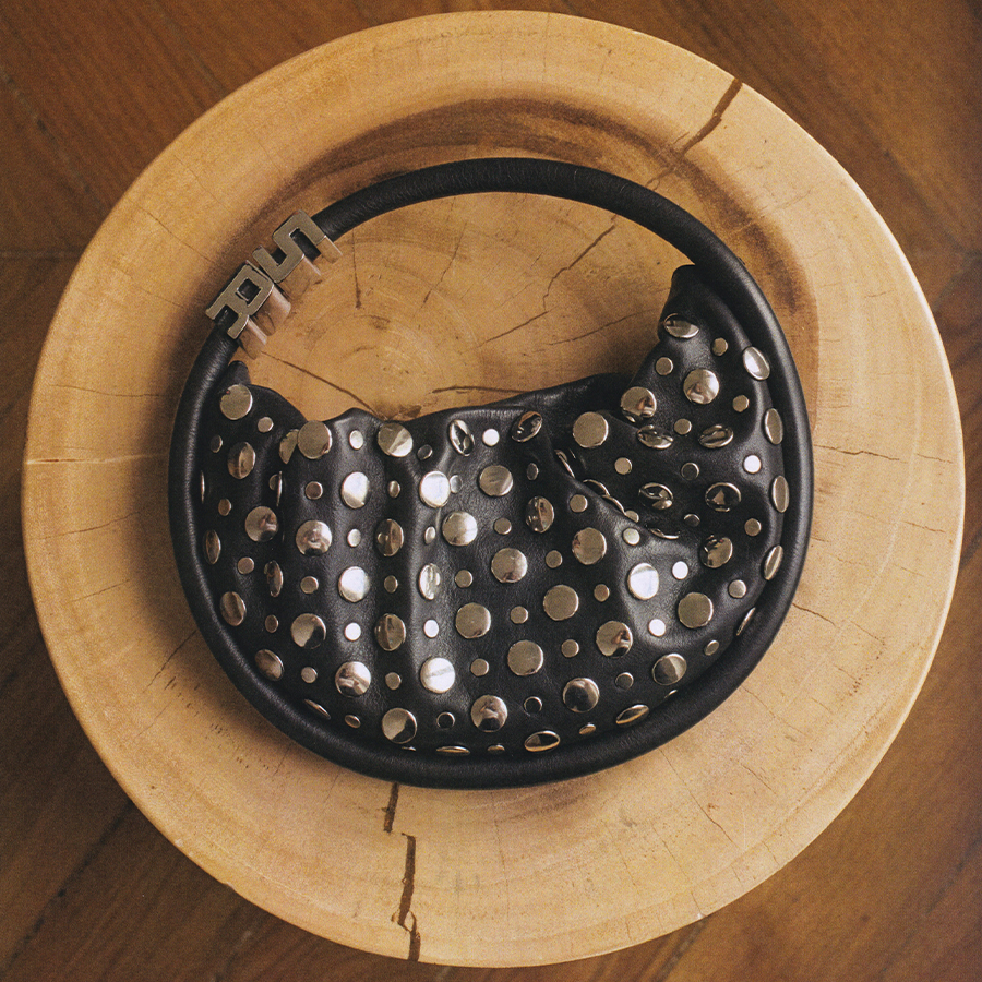 Women holding a designer handbag - Black