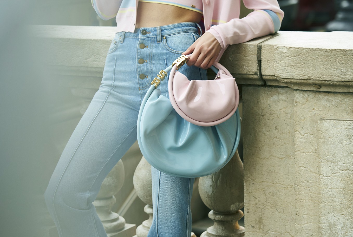 A woman wearing the new two pastel Domino bags