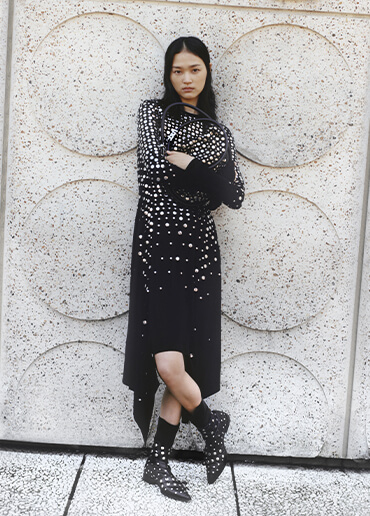 A woman wearing a new luxury black dress from the sonia rykiel FW23 women collection