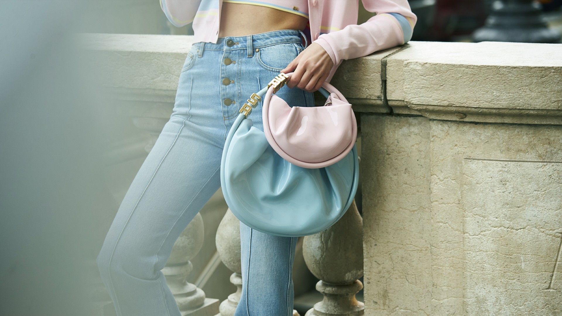 A woman wearing the new two pastel Domino bags