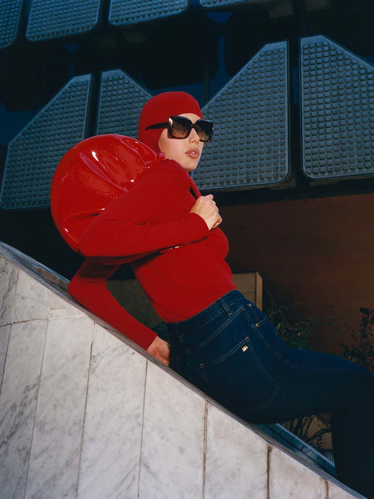 Woman wearing a designer red handbag